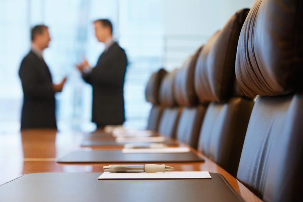 Boardroom meeting discussing what to do when the CEO quits