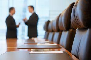 Boardroom meeting discussing what to do when the CEO quits