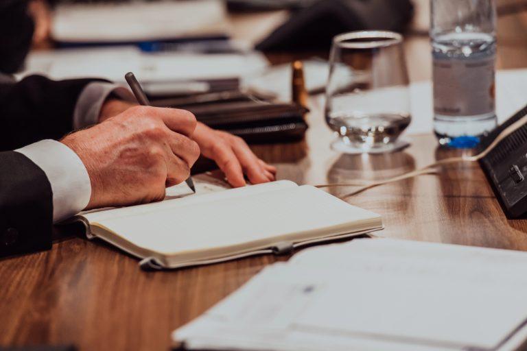Business owner taking notes while evaluating outsourced CFO provider candidates