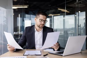 Business owner reviewing financial documents with an outsourced CFO