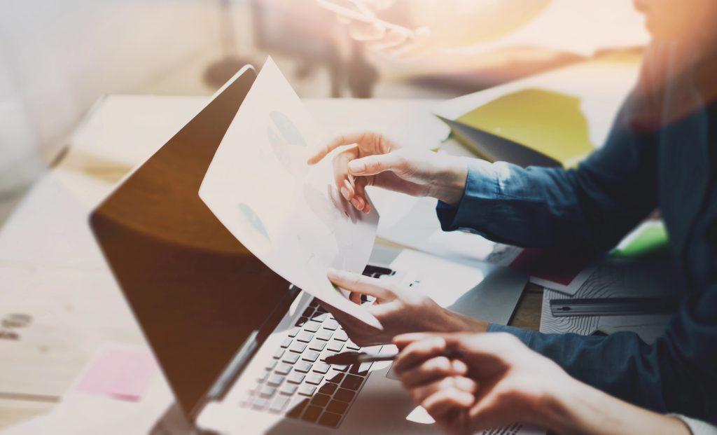 Business owner and fractional CFO reviewing financial charts during a strategy session